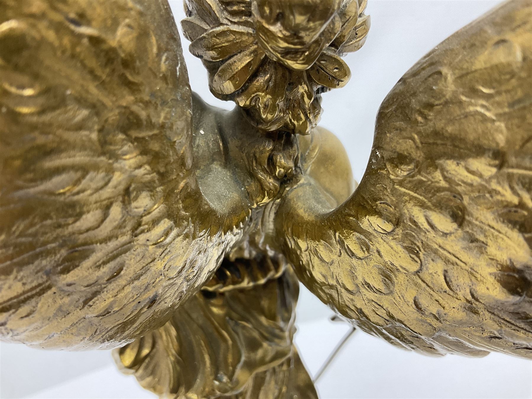 After Oswald Schimmelpfennig (German, 1872-1939): Pair of gilt bronze winged Allegorical female figures, the first example with arm outstretched holding a branch, signed 'Schimmelpfennig 1900', the second with arm raised above her head holding a book and sword in the other, both raised upon marble plinths, H45cm