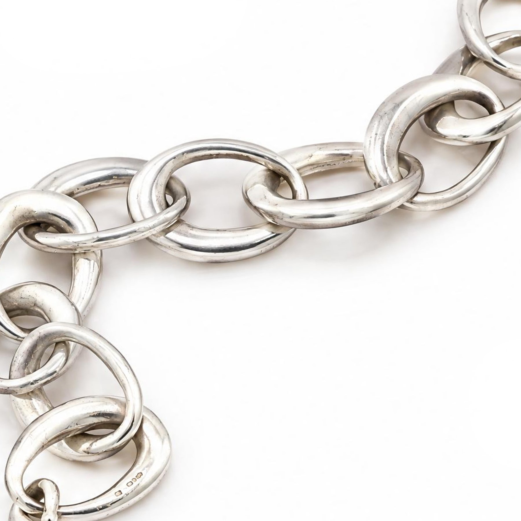 Chanel silver bracelet, with ten oval interlocking links and a hook clasp, London 2000