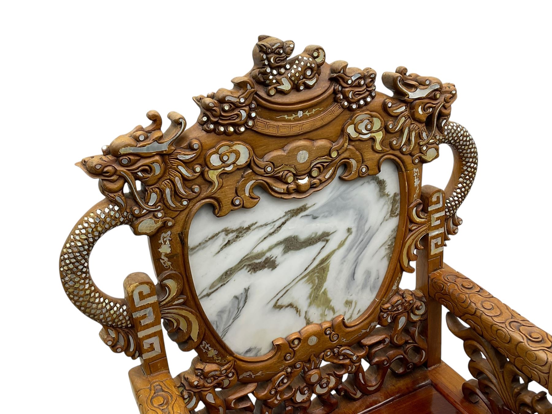 Pair of Chinese hardwood throne chairs, the back with grey marble inset surrounded by carved dragons and masks, inlaid with mother of pearl, the arm terminals carved with dragons, panelled seats inlaid with flowers and foliate motifs, on ball and claw carved cabriole feet