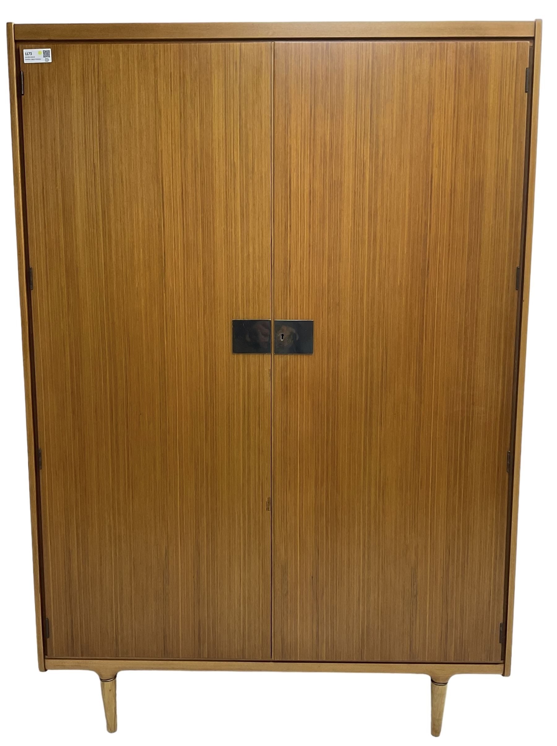 Wrighton - mid-20th century teak wardrobe, two doors enclosing hanging rail, shelves and hinged compartments, on turned tapering feet