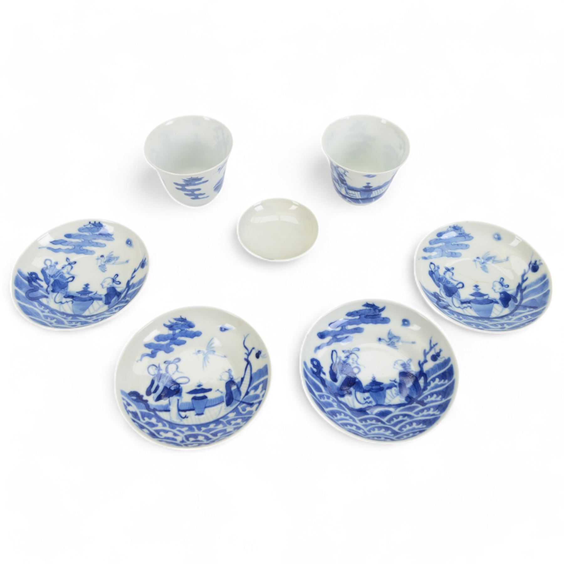 Pair of Chinese blue and white tea bowls, one with cover and four saucers, depicting two figures on a boat at sea, tea bowl H7cm