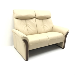  Komfort two seat sofa, upholstered in beige leather (W141cm) and two matching swivel recliner chairs (W82cm) (3)  