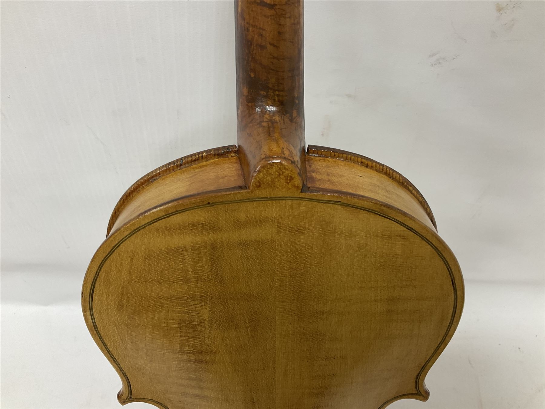Copy of a full size Stradivarius violin, with an ebonised fretboard, tailpiece and tuning pegs, with a polished chin rest  Length 60cm