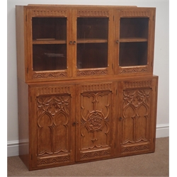  Mid to late 20th century light oak Gothic Revival wall unit, three glazed doors above three panelled cupboards, arcade and lunette carved doors with tracery work, W107cm, H120cm, D64cm  
