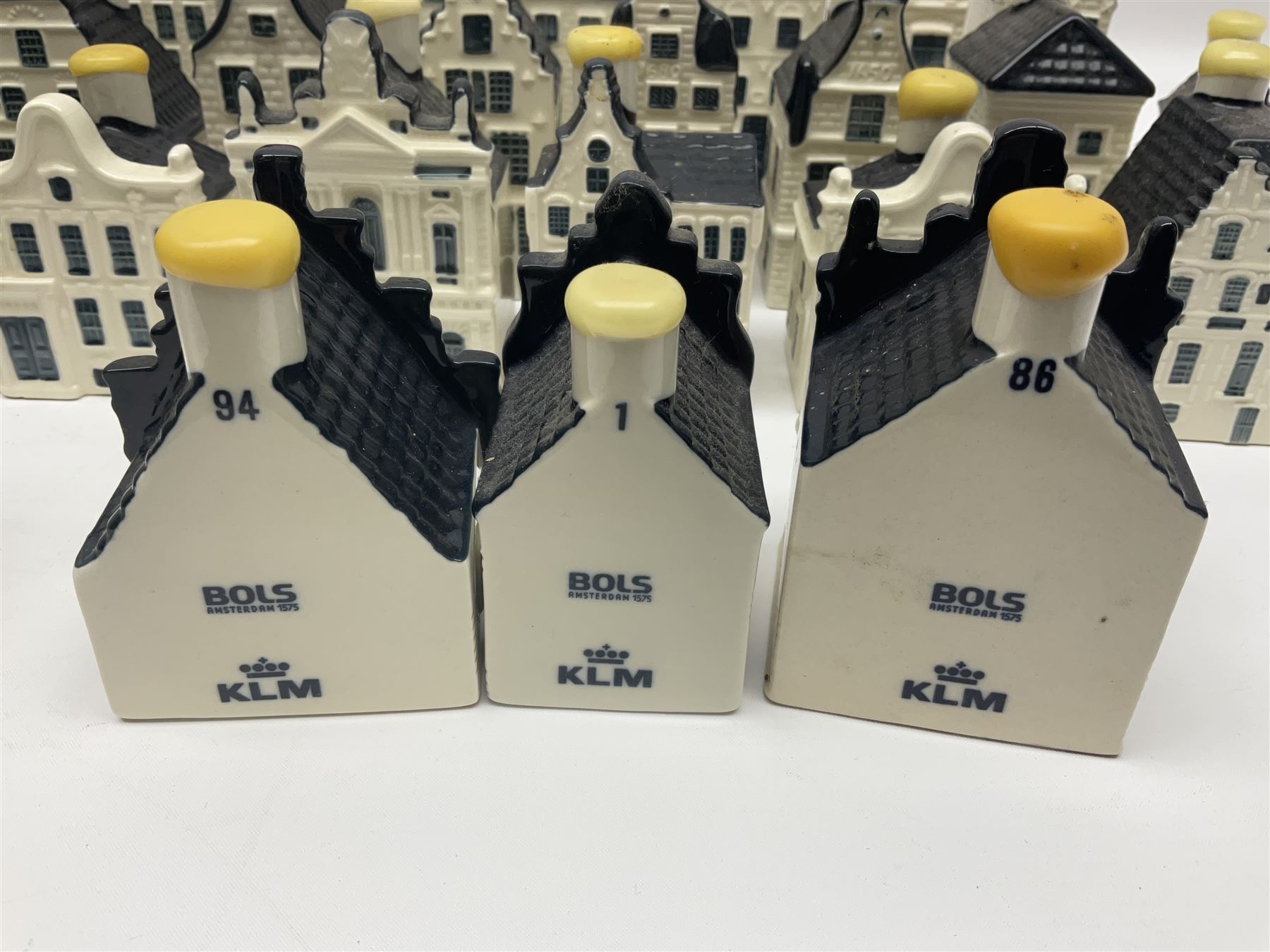 Twenty seven KLM Bols Blue Delft's decanters in the form of Dutch houses, some with contents