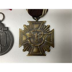 WW2 German Eastern Front Medal awarded to those who served on the German Eastern/Russian Front during the Winter Campaign period of 15th November 1941 to 15th April 1942 with original ribbon; German War Merit Cross with swords; and NSDAP Long Service Award (3)