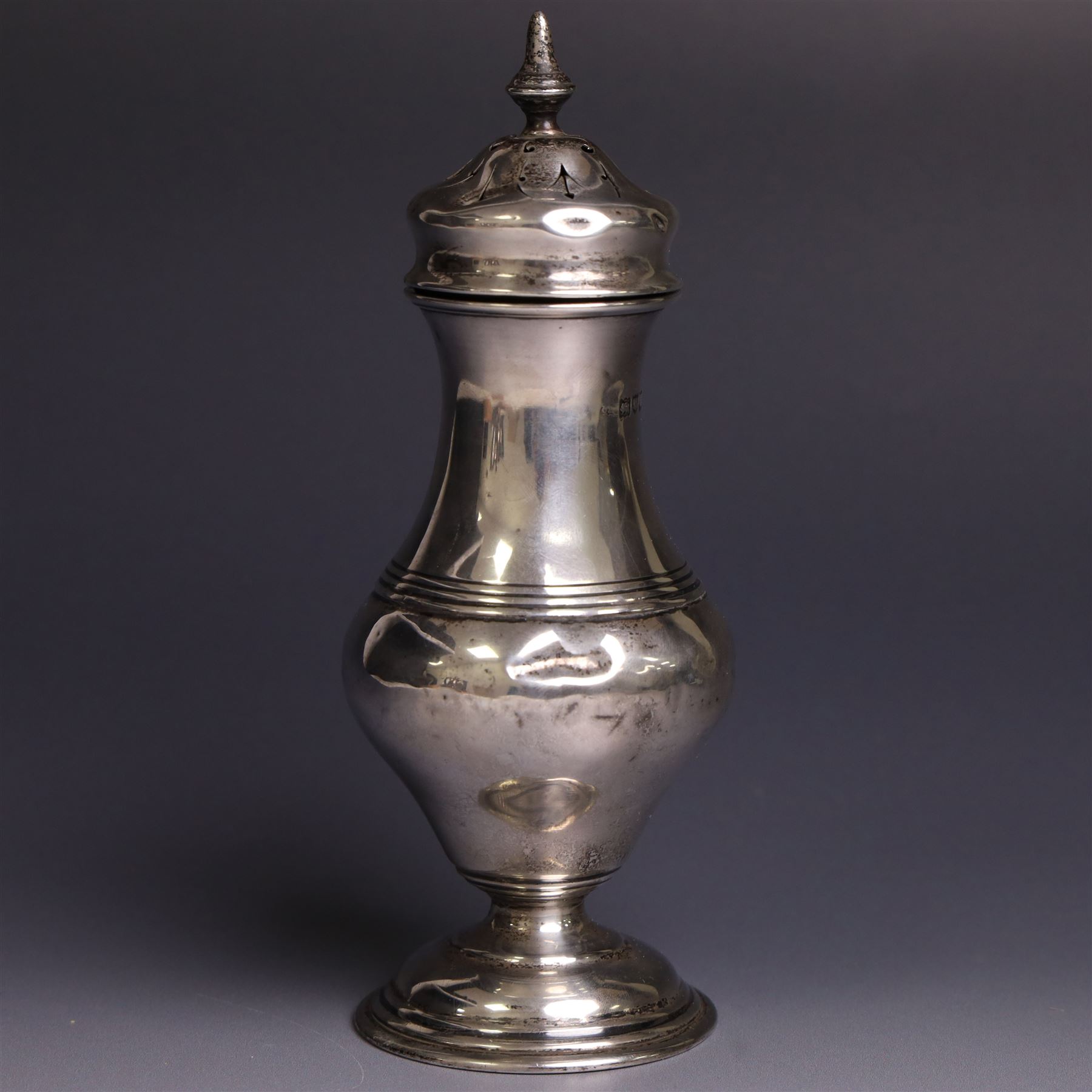 Early 20th century silver sugar caster, of typical form with removable pierced cover and upon circular foot, hallmarked Charles Edwards, London 1916, H18cm