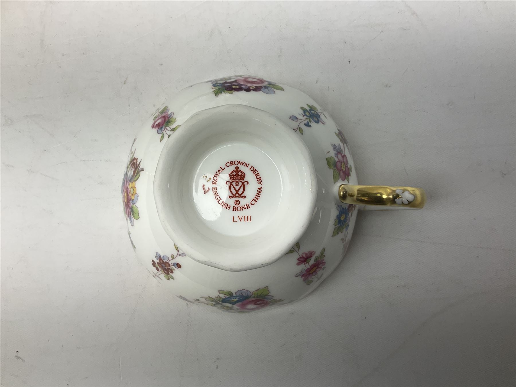 Coalport Revelry pattern tea and dinner wares, comprising nine dinner plates, four salad plates, eleven side plates, sauce boat and stand, ten teacups and ten saucers, and preserve pot and cover, together with a Coalport plate of shaped form decorated with pink roses, and a Royal Crown Derby Royal Antoinette pattern trio