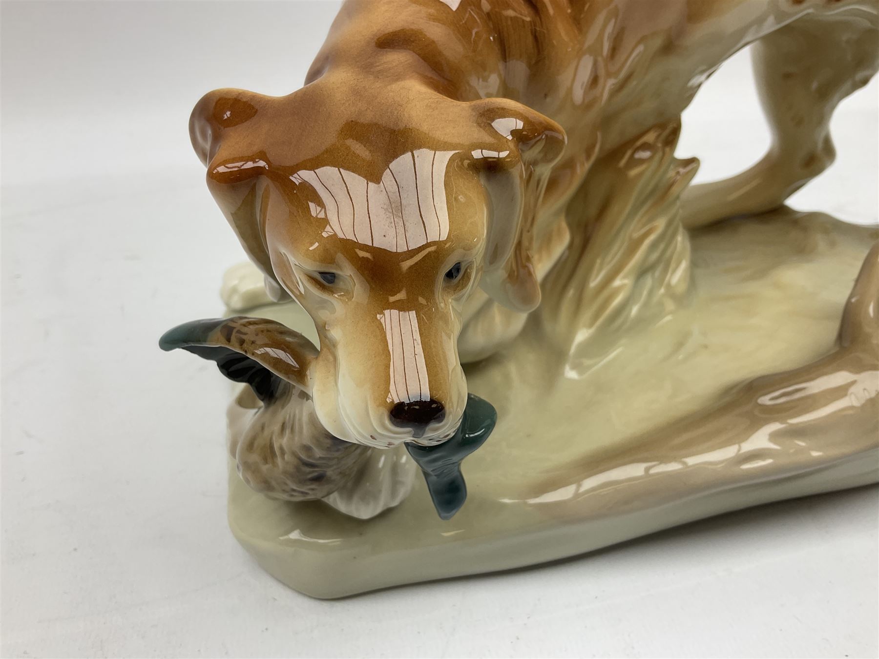 Royal Dux porcelain hunting dog with a bird, printed mark beneath, L36cm