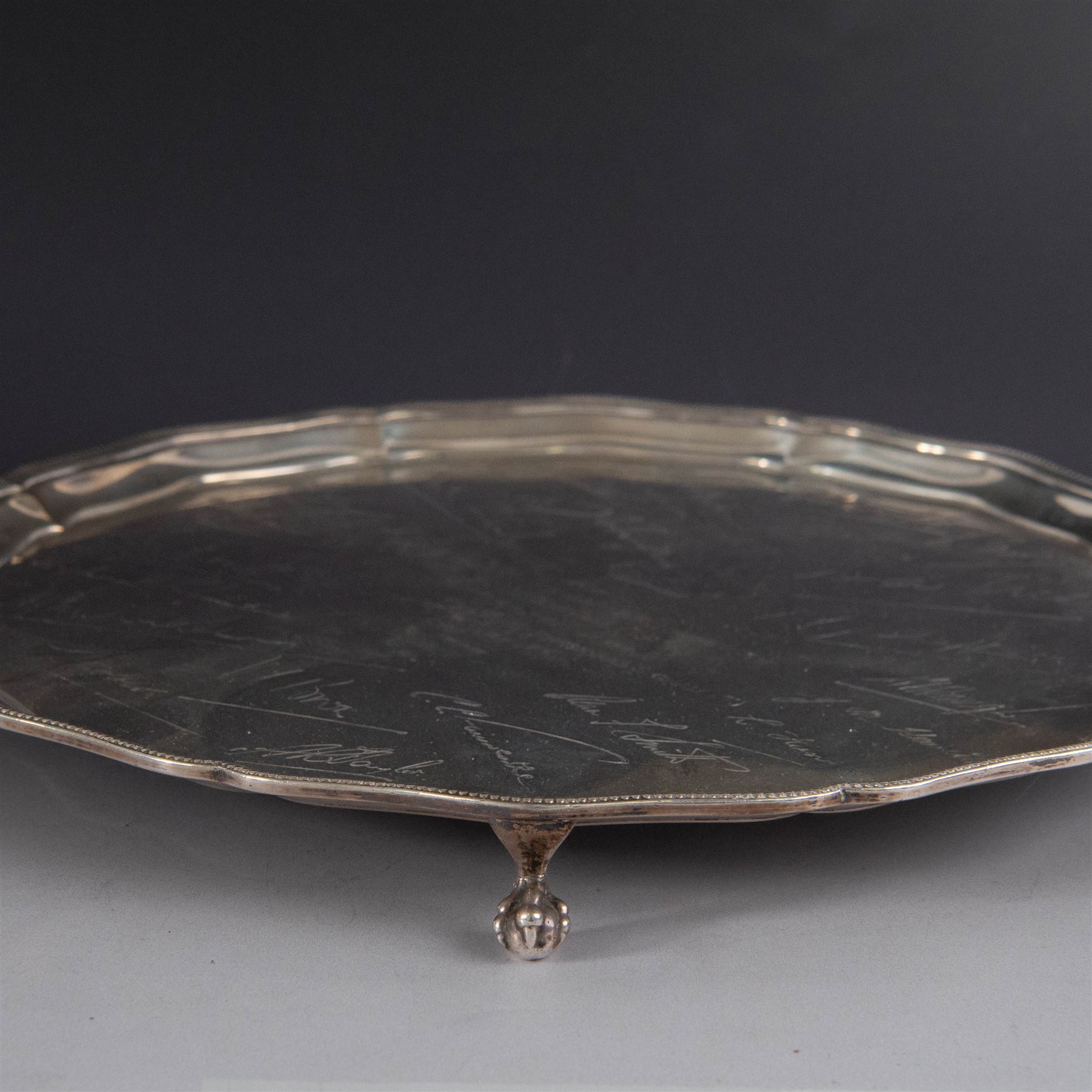 1930s silver salver, of circular form with beaded pie crust rim and upon four claw and ball feet, with presentation engraving to centre reading 'Presented to Second Lieutenant FR Himsworth Royal Signals by the Officers of the 50th Nottingham Motor Divisional Signals on the Occasion of his Marriage 10th September 1939', bordered by the engraved signatures of his colleagues, hallmarked Barker Brothers Silver Ltd, Birmingham 1938, D25cm