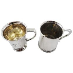 Two 1930's silver christening mugs, the first example of slightly tapering form with lipped rim, flat topped curved handle, upon a circular stepped foot, hallmarked C W Fletcher & Son Ltd, Sheffield 1936, H8.5cm, the second also with lipped rim, engraved initials to body and curved handle, upon a circular stepped foot, hallmarked William Adams Ltd, Birmingham 1936, H8.5cm, approximate total weight 7.02 ozt (218.5 grams)





