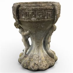 Cast stone urn with two figures supporting the bowl