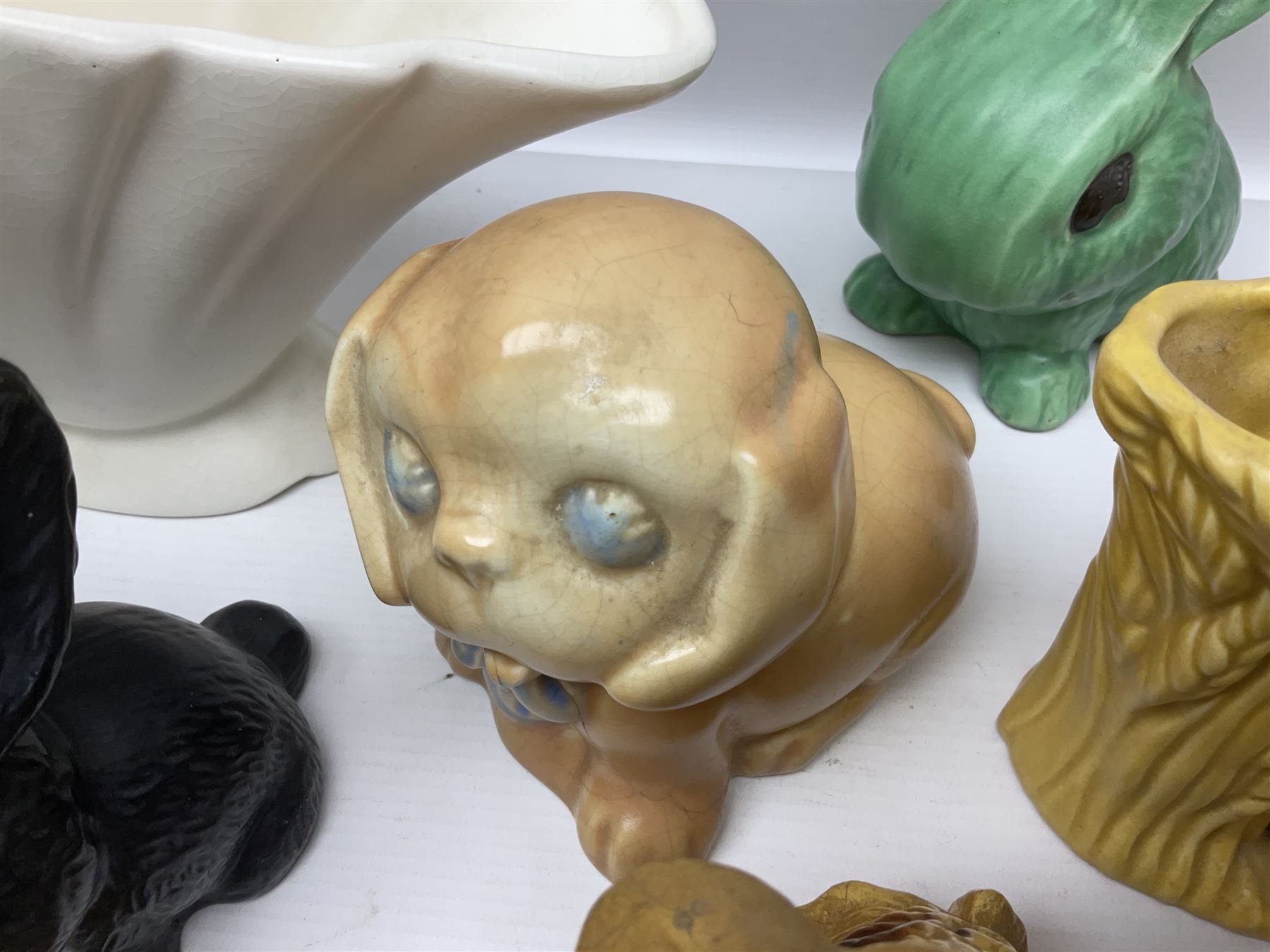 Collection of Sylvac and similar animal figures, including rabbits, hares and dogs, together with Falcon budgie vase, etc 