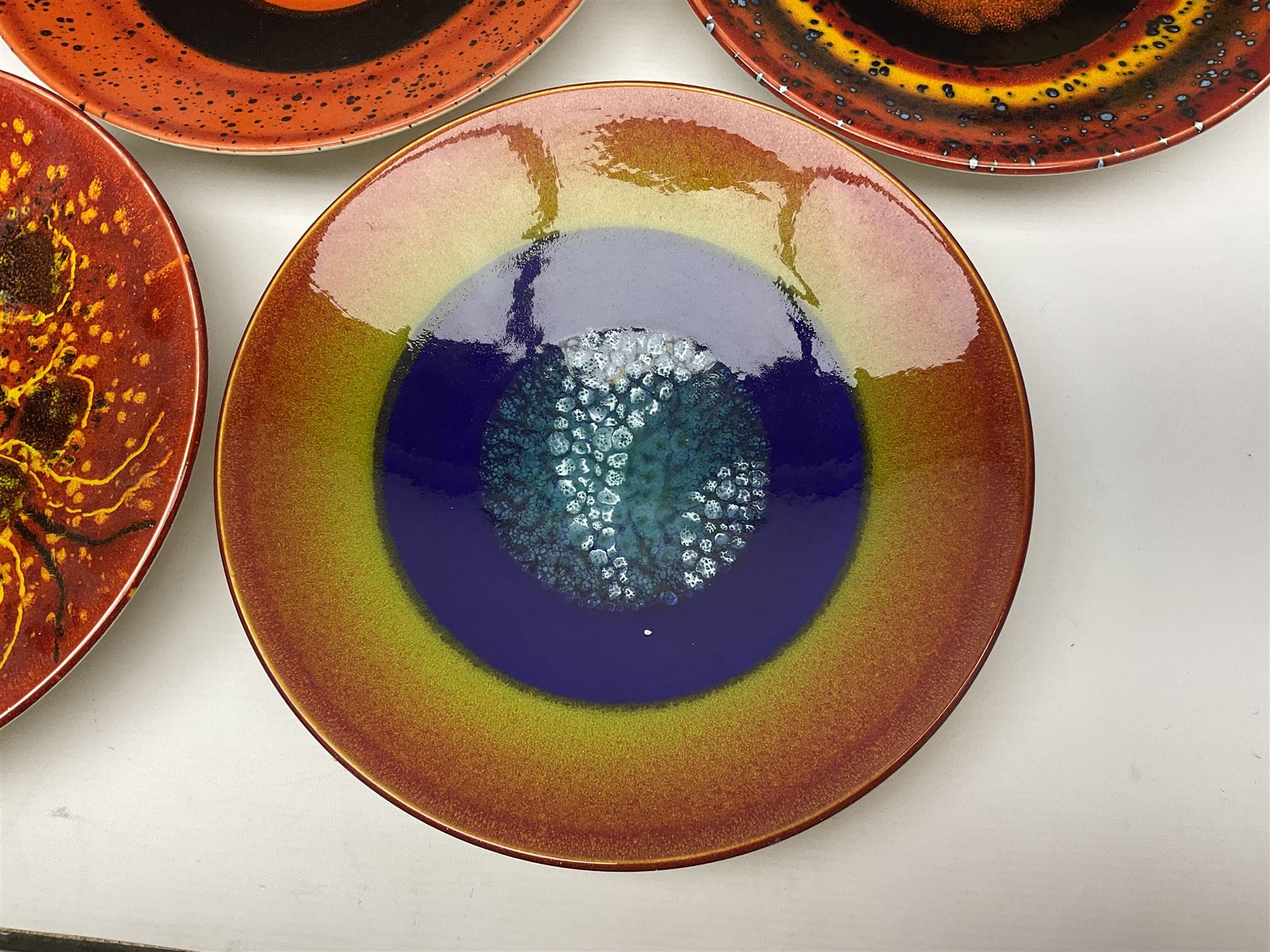 Poole Pottery The Planets, set of nine chargers 'The Planets, by Alan Clarke, comprising Mars, Mercury, Neptune, Venus, Uranus, Pluto, Jupiter, Saturn and Earth, all with original boxes and certificate, D27cm 