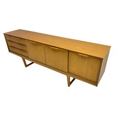 Stonehill Furniture (SF) Ltd - mid-20th century teak sideboard, rectangular topover three drawers, two cupboard doors and fall-front drinks cupboard, raised on square tapering supports