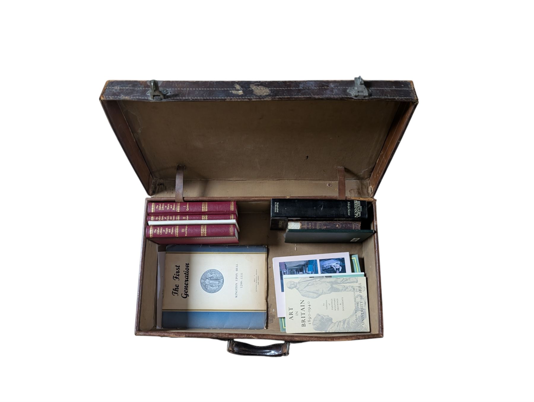 Collection of books, including Art in Britain 1890-1940 from the collection of The University of Hull and The Humber by Anthony V Watts, housed within a leather suitcase decorated with various travel labels 