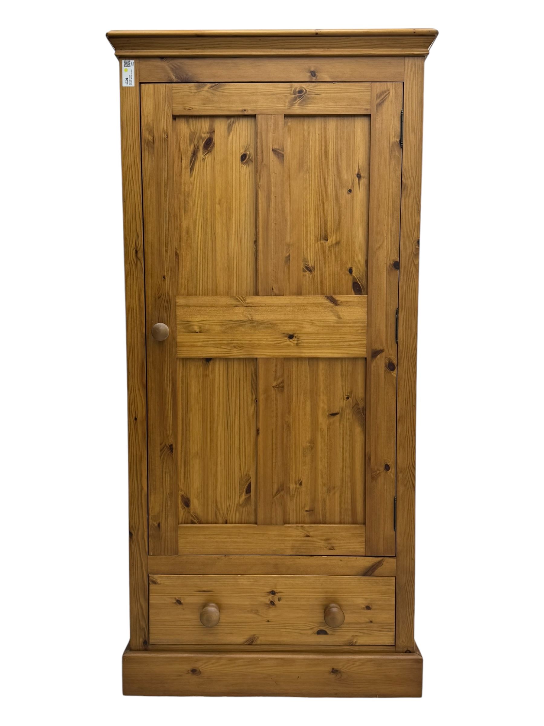 Pine single wardrobe, enclosed by single panelled door, fitted with single drawer, on plinth base 