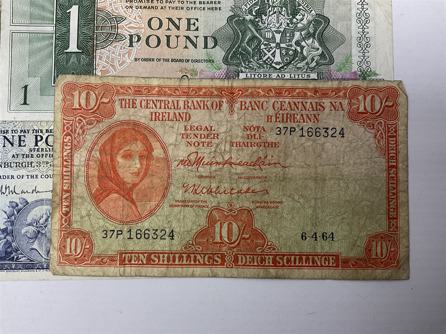 Irish and Scottish banknotes to include Bank of Ireland 5 January 1939 ‘B15’ one pound, two Bank of Scotland 1964 ‘AD07’ and ‘AF05’ one pound notes, one 1966 ‘CQ77’ one pound, and further notes from Clydesdale Bank, National Commercial Bank of Scotland Ltd. etc, housed in plastic sleeves