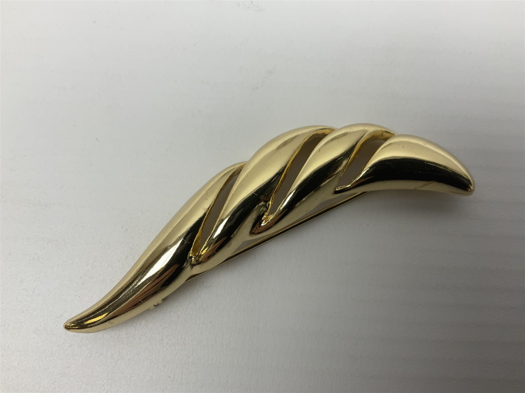 Christian Dior costume jewellery, comprising pair of pearlescent clip on earrings, enamel and paste leaf brooch and a pierced stylised leaf brooch, each stamped Chr.Dior Germany and in original boxes