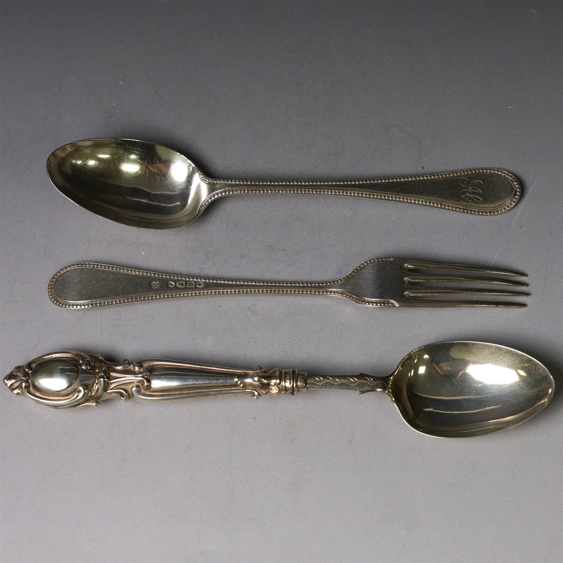 Victorian silver spoon and fork set, each with bead rim and engraved monogram and a silver spoon with scroll handle, with bright cut engraving to underside of bowl, all hallmarked 
