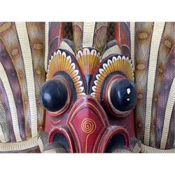Sri Lankan Cobra mask depicting the demon Naga Raksha, together with a smaller example, largest H46cm