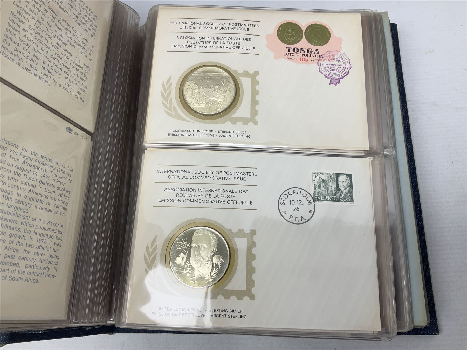 Thirty-six 'International Society of Postmasters Official Commemorative Issues' sterling silver proof medallic covers dating from 1975 to1977, housed in the official folder