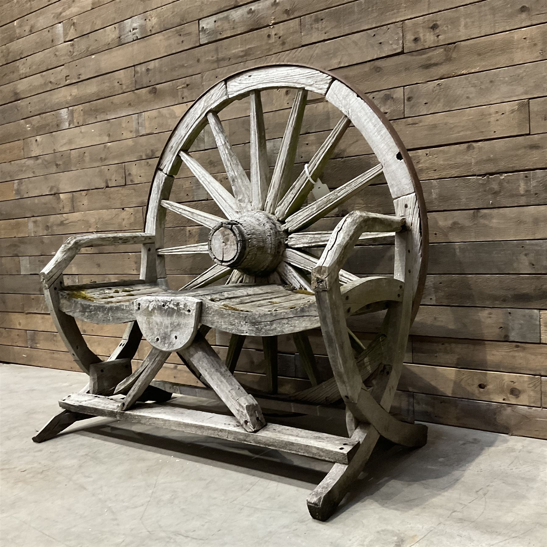 Early 20th century timber framed cartwheel garden bench