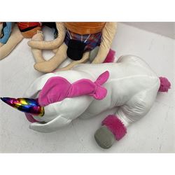 Three large ALDI Kevin carrots and giant unicorn stuffed toy together with quantity of smaller carrots