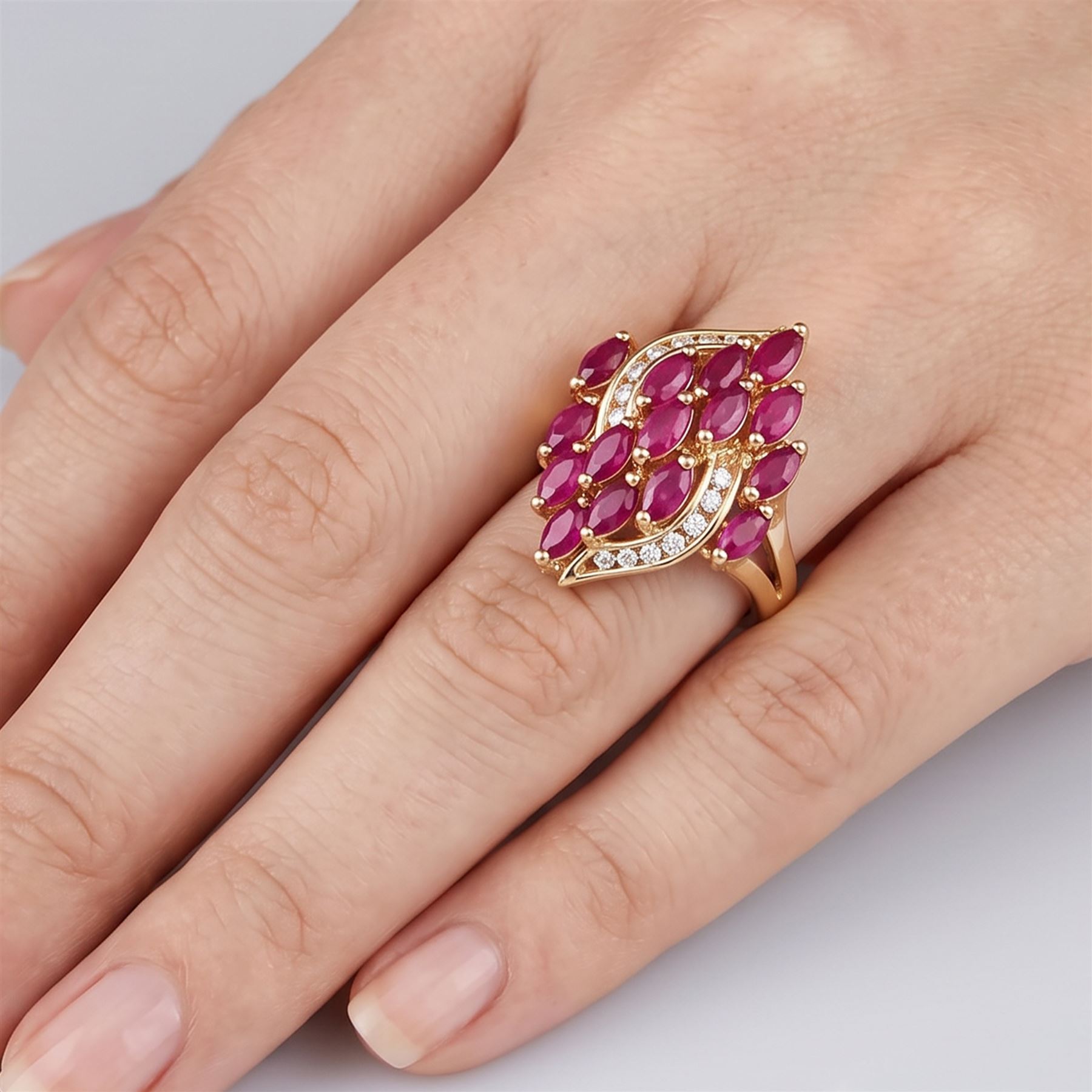 14ct gold ruby and diamond cluster ring, set with fifteen marquise cut rubies and fourteen channel set round brilliant cut diamonds, stamped 585