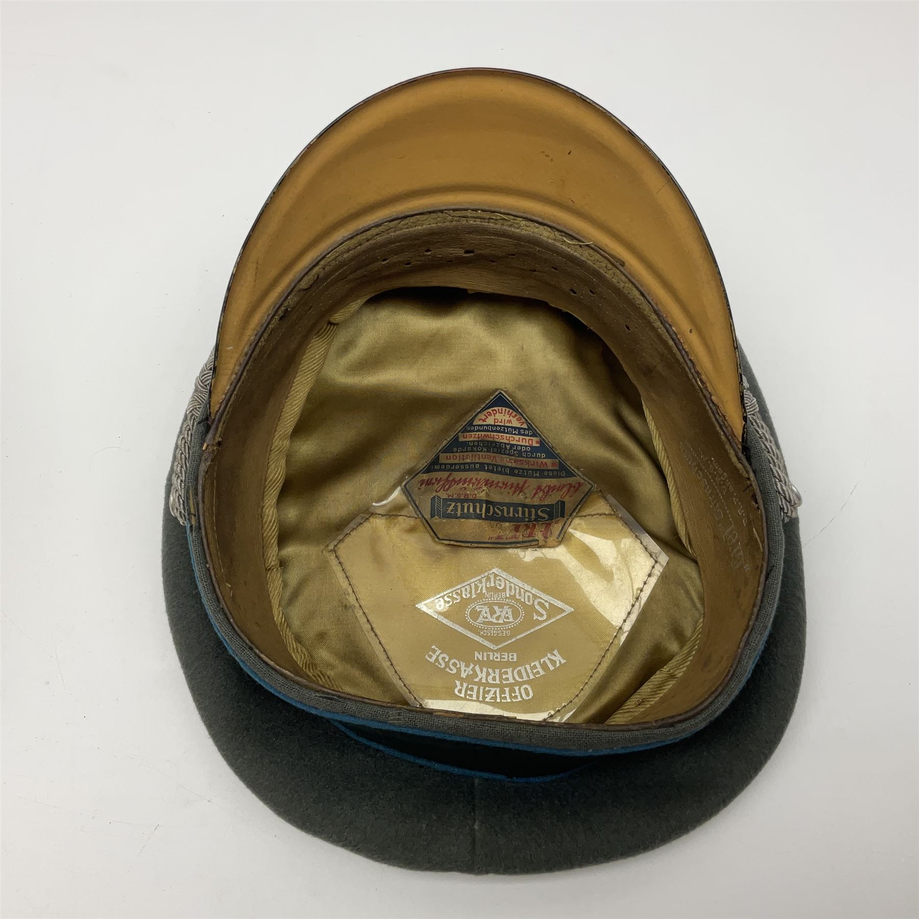 WW2 German Infantry Officer's visor cap with cloth insignia; labelled and stamped Offizier Kleiderkasse Berlin and Erel Stirnschutz