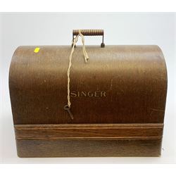 A cased vintage Singer hand crank sewing machine. 