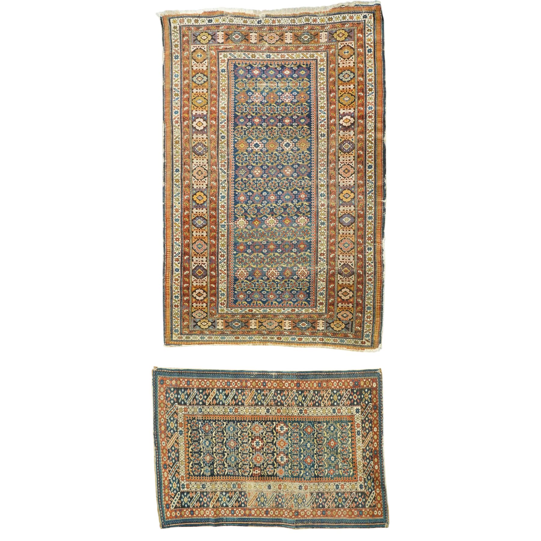 Two antique Caucasian Shirvan rugs, indigo field decorated with horizontal bands of small geometric floral and star motifs within multiple finely drawn borders featuring diamonds, rosettes, and stylized leaves in a palette of madder red, ivory, ochre, and pale blue, with fringe ends, 195x137cm, together with a similar smaller rug, 143x96cm