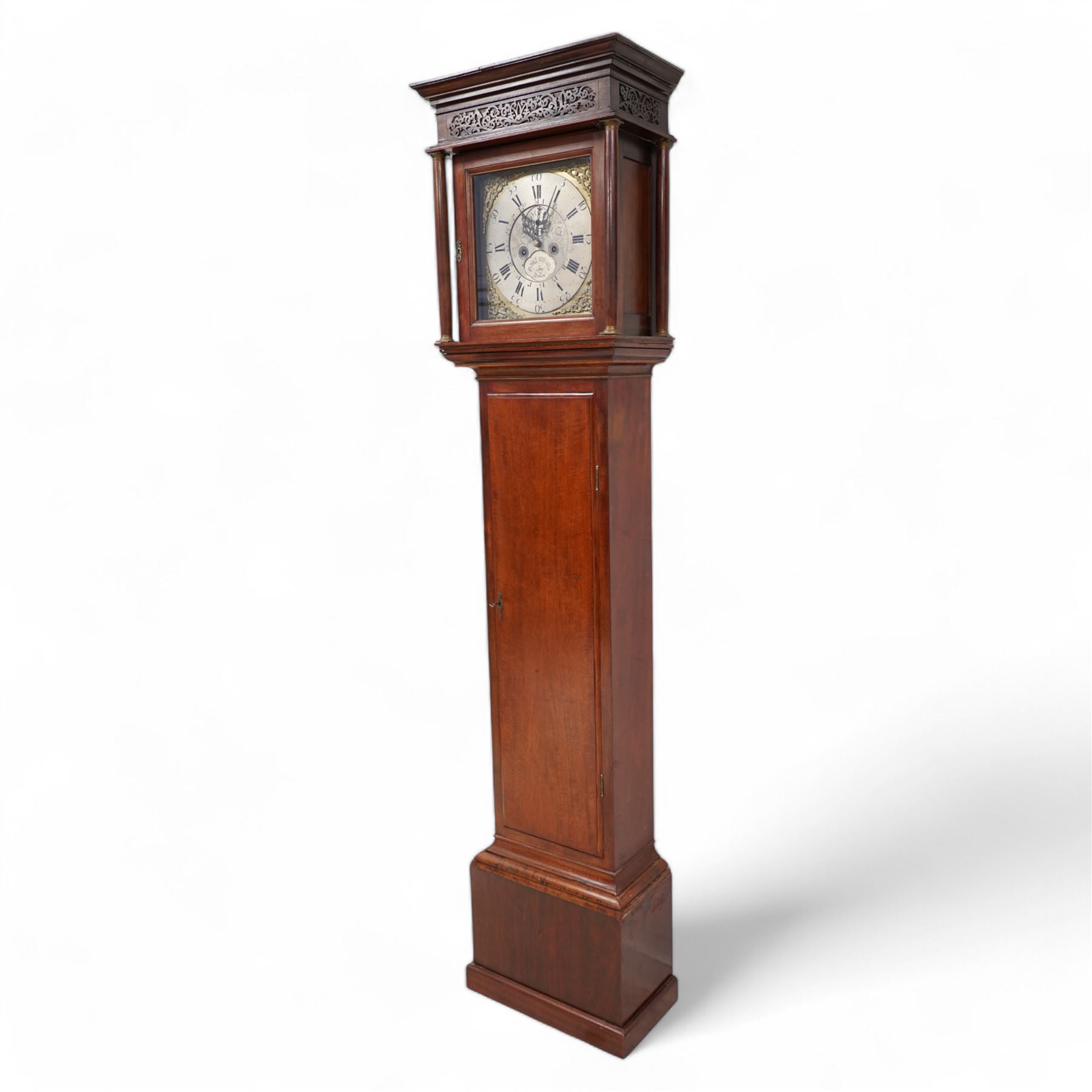 Mahogany - 8-day longcase clock, with a flat pediment and blind fret frieze beneath, square hood door with detached freestanding pilasters, trunk with a flat topped door on a short plinth with applied skirting,  square brass dial with cast spandrels and a silvered chapter with Roman numerals and five-minute Arabic's, engraved dial centre with seconds dial and silvered cartouche inscribed 