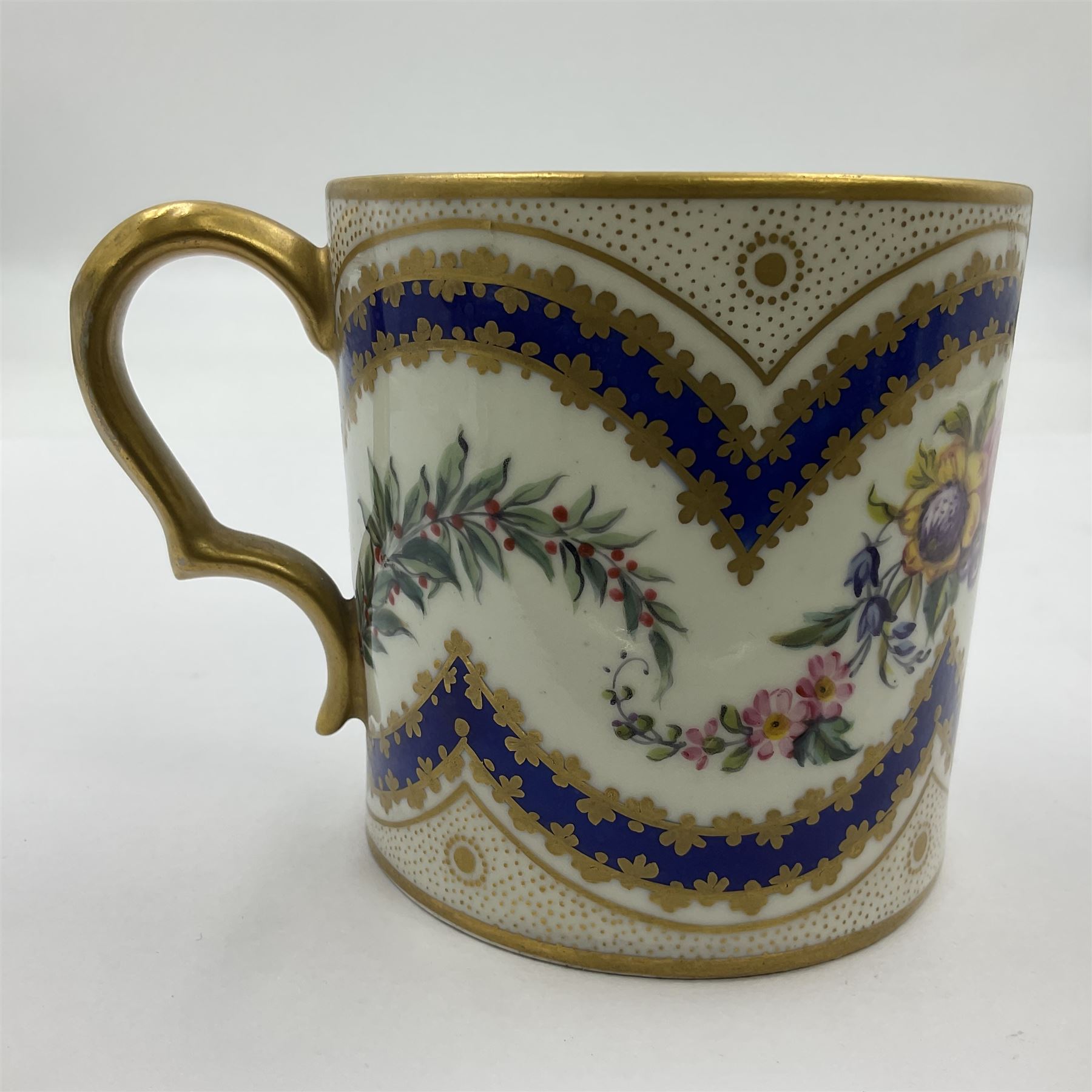Sèvres soft paste porcelain coffee can and saucer with date code for 1767, painted with floral and laurel leaf garlands within blue scalloped and gilt borders, interlaced LL monogram enclosing the date letter O above painters mark for Catrice, coffee can H7.5cm, saucer D15cm