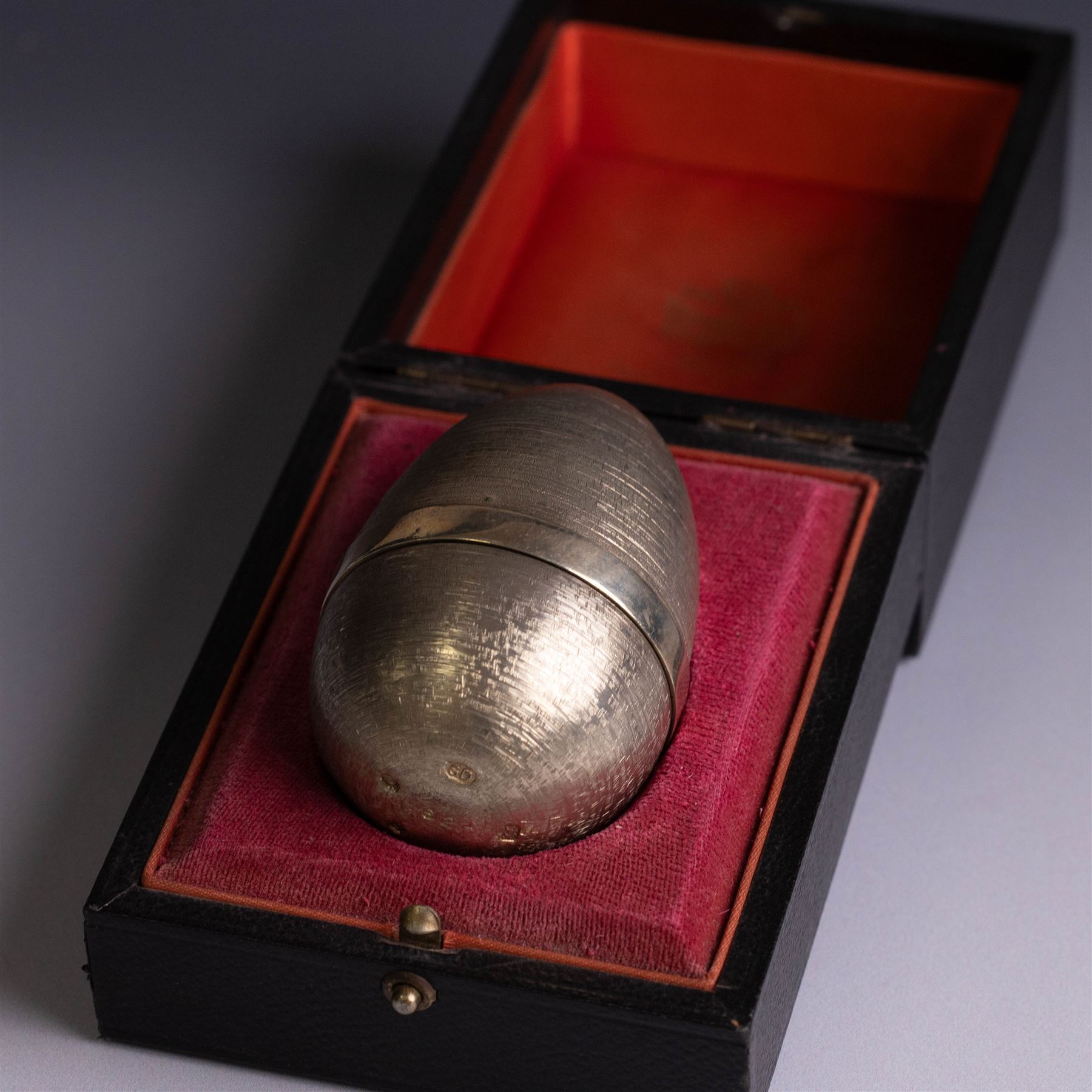 Stuart Devlin - Late 20th century silver and silver-gilt surprise egg, the textured gilt exterior opening to reveal an underwater scene with two fish and an anchor, hallmarked Stuart Devlin, London 1977, boxed, H10cm