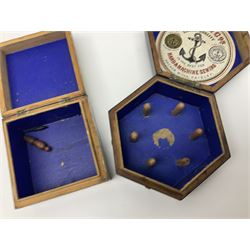 Mauchline ware black lacquered octagonal bobbin box, the hinged cover with forget-me-not floral decoration and sentimental verse, opening to reveal six bobbin holders and retail label for Clark & Co, together with a Mauchline ware sewing box, with floral decoration throughout and verse to hinged cover, a similar black lacquered needle holder and a Mauchline Tartan ware needle holder, largest diameter D11.5cm