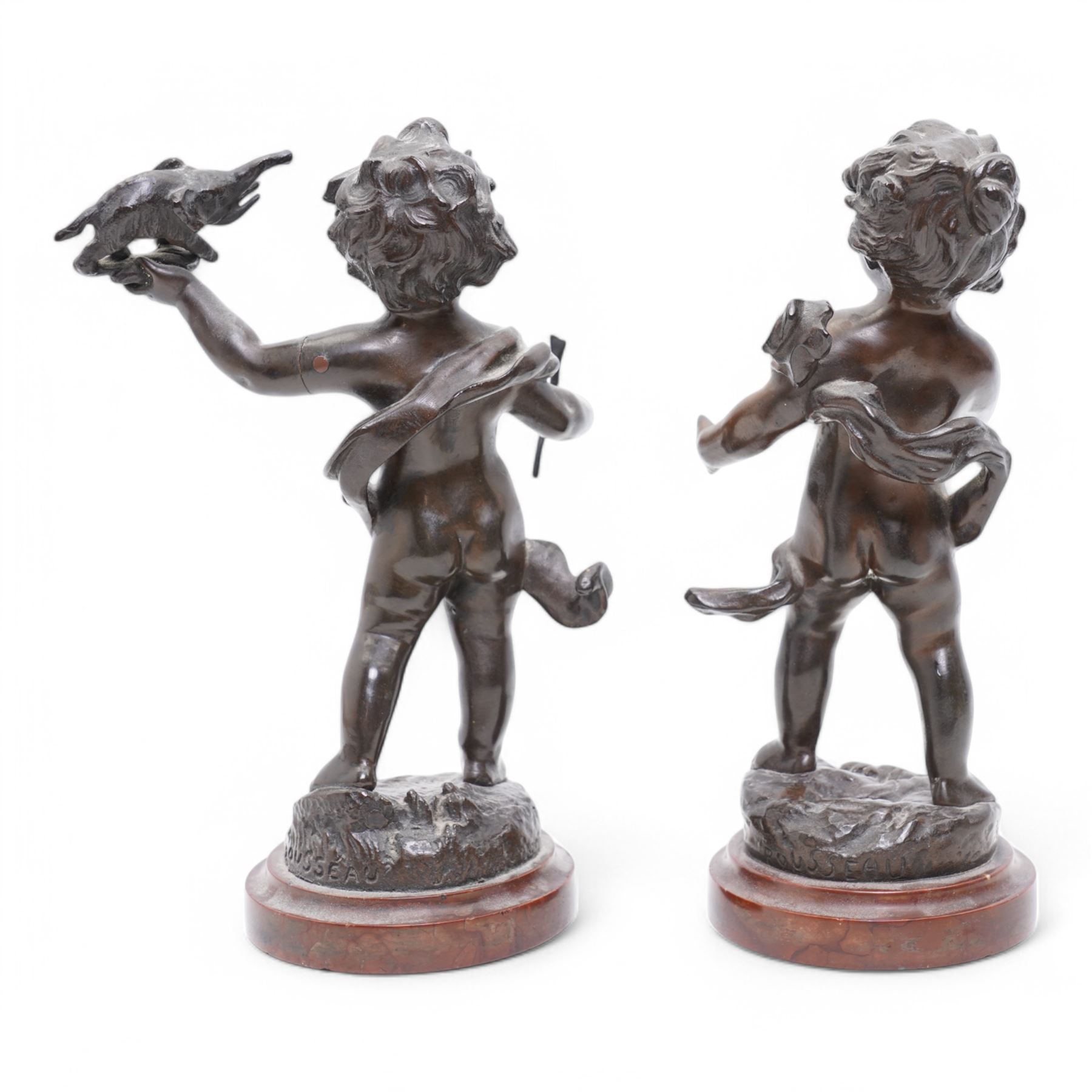 After Rousseau - Pair of bronze figures of cherubs, one holding a toy elephant, the other originally with an artists board on marble bases H23cm