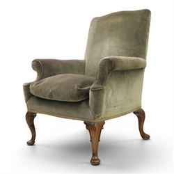 Pair of Georgian style wing armchairs, upholstered in green velvet, each with shaped wing backs, padded scroll arms and loose seat cushions, raised on cabriole supports terminating in pad feet, one with tasselled fringe
