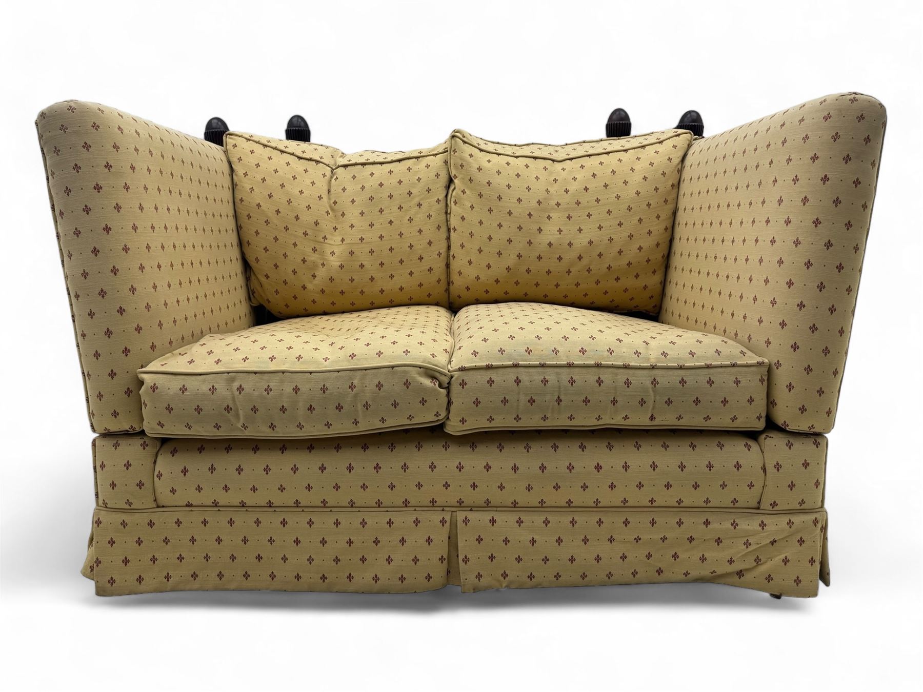 20th century Knole design two seat sofa, high back and double drop-arm joined by mahogany finials and ties, upholstered in camel ground fabric with red lozenge design, on turned supports with brass castors