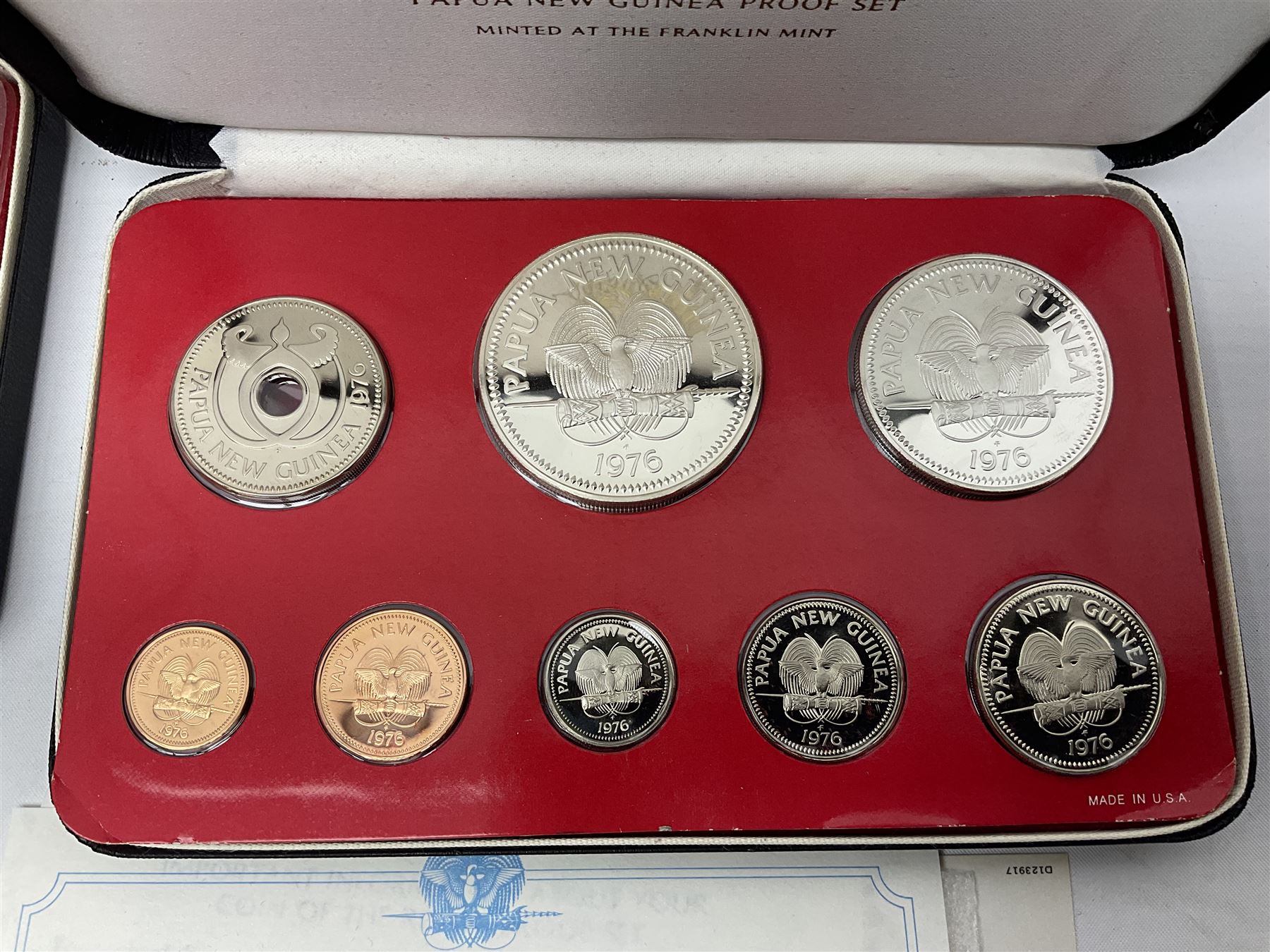 Four Papua New Guinea proof eight coin sets, from ten kina to one toea, comprising First Coinage of Papua New Guinea 1975 proof set, 1976, 1977, and 1979 proof sets, the 1977 and 1979 sets containing 925 silver ten kina and 500 silver five kina coins, all minted at the Franklin Mint, cased with certificates (4)