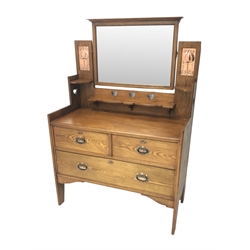  Arts & Crafts ash raised bevel edge mirror back dressing  chest by Shapland and Petter, two inset embossed brass plaques, pierced with hearts, two short and one long drawer, W107cm, H156cm, D51cm   