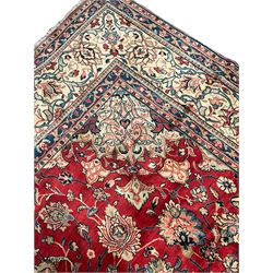 Persian Mahal carpet, red ground with overall floral design, decorated with stylised flower heads and bird motifs, scrolling multi-band border