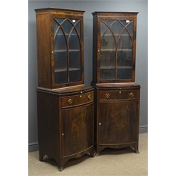  Pair early 20th century bow front cabinets, projecting detail cornice, glazed doors enclosing three shelves above a slide, drawer and cupboard, on splayed bracket feet, W57cm, H184cm, D48cm   
