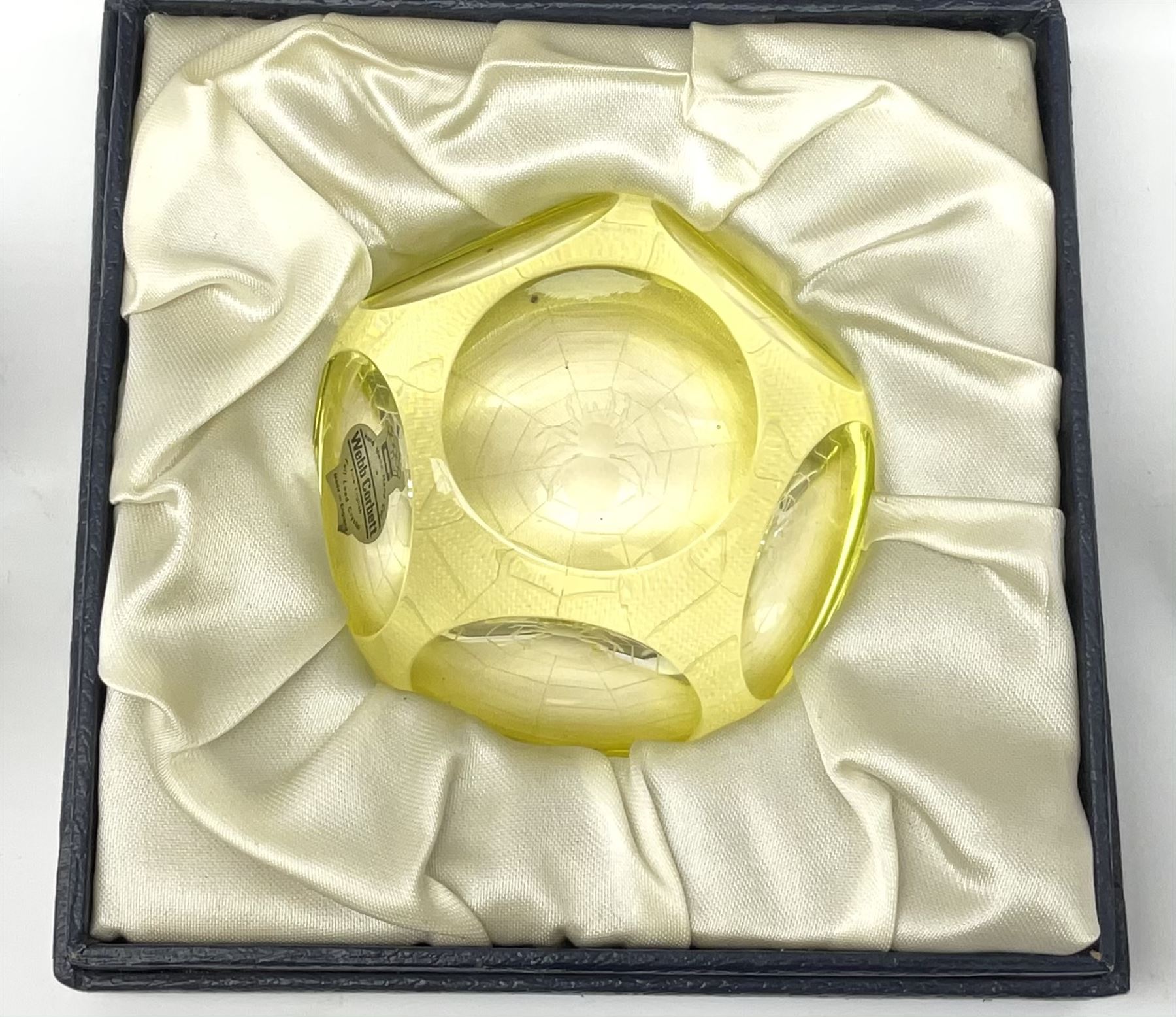 A group of six Webb Corbett faceted glass paperweights, to include one blue example, and one yellow example in makers box. 