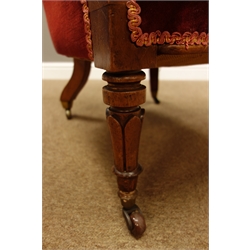  Regency period mahogany open armchair, buttoned back, upholstered arms with scroll carved terminals, turned feet on castors, in red velvet  
