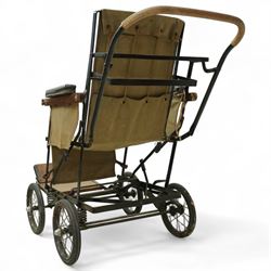 *Early 20th century invalid chair, the tubular metal frame with folding mechanism, canvas seat and back, padded armrests, raised on coil springs and large spoked wheels with wooden footrestFrom the Kirkham Hall Attic & Cellar Collection, sold without reserve