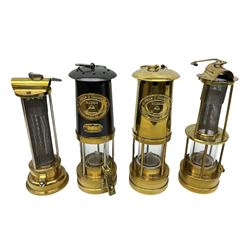 Four miners lamps, comprising Clanny miners lamp, with flip top and gauze protected by three rods, stamped E.T.W E-3, lamp with a gauze chamber protected by three rods, and two E. Thomas & Williams Ltd lamps, tallest example H26cm