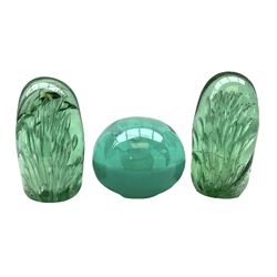 Pair of Victorian green glass dump paperweights with air bubble inclusions, and another example with internal foil flower decoration, tallest example H16cm