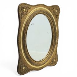 Early 20th century giltwood mirror, oval mirror plate, surrounded by egg and dart moulding...