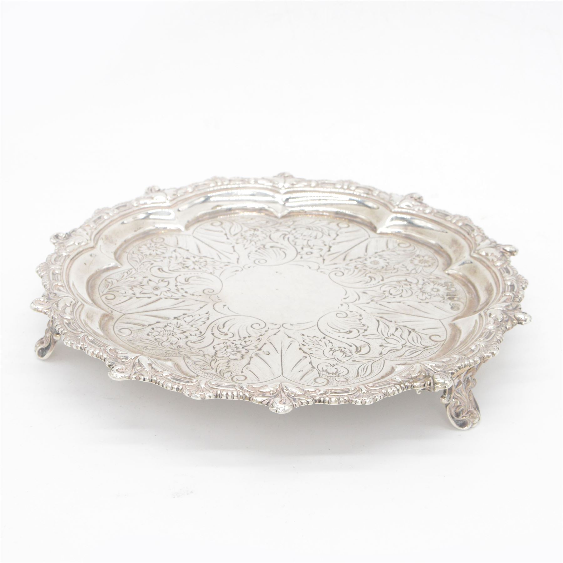 George IV silver waiter, of typical form, with shaped rim embossed with C scrolls, upon three scrolling pad feet, hallmarked William Brown London 1829, D20cm